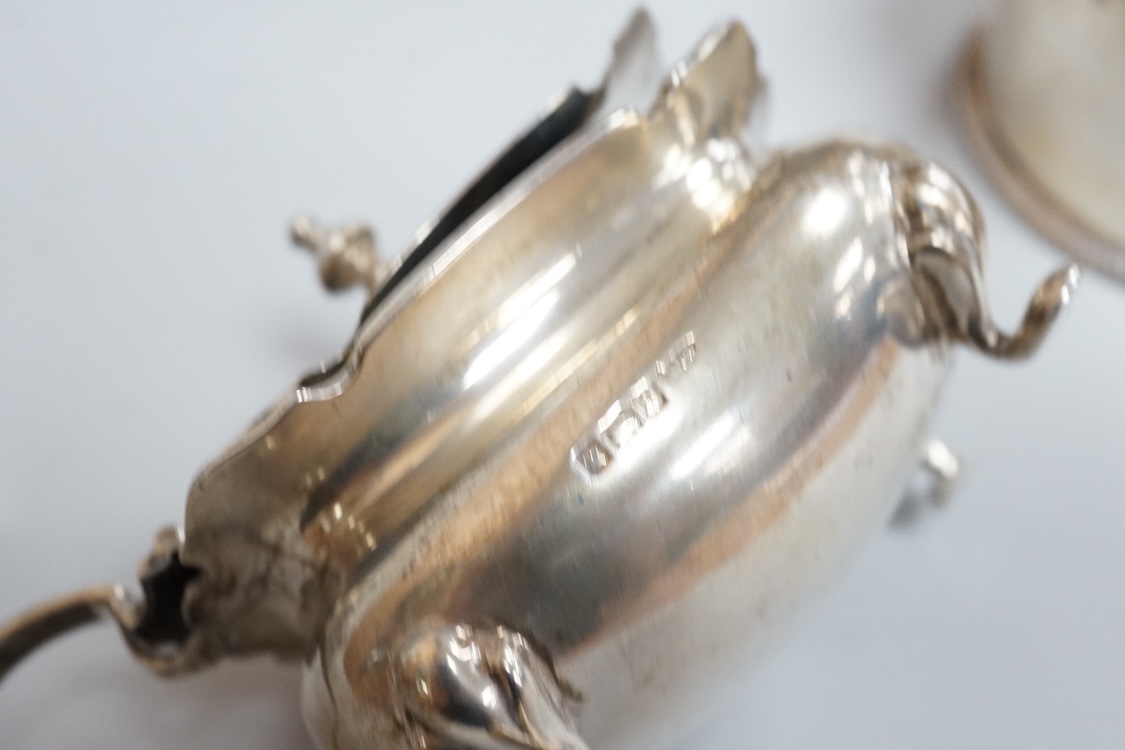 A pair of George III pierced silver shaped oval salts by Hester Bateman, London, 1783 (a.f.), with clear glass liners, together with one other George III silver oval salt, London, 1783 and two later silver mustard pots.
